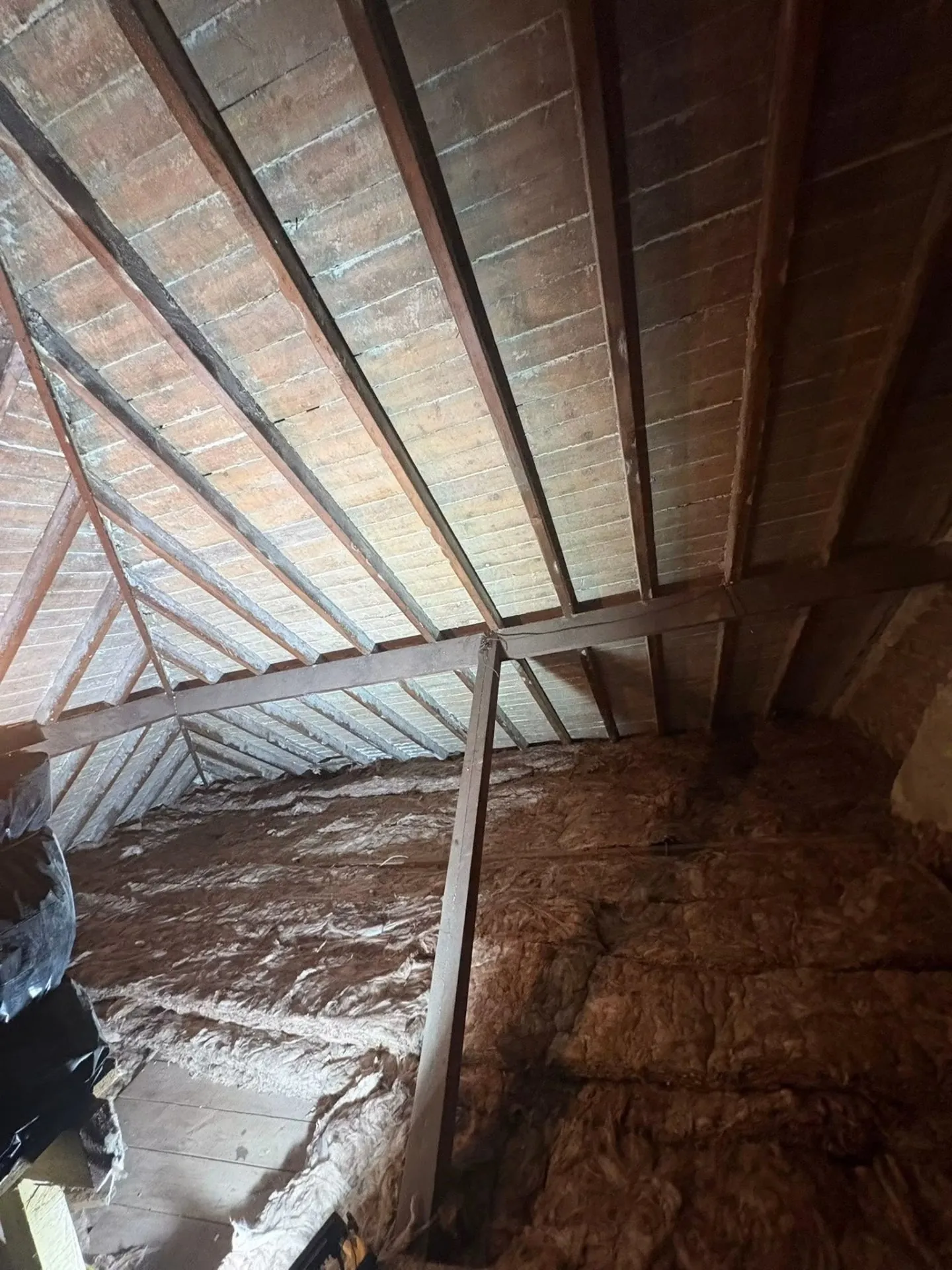 Loft after full spray foam removal with rafters exposed